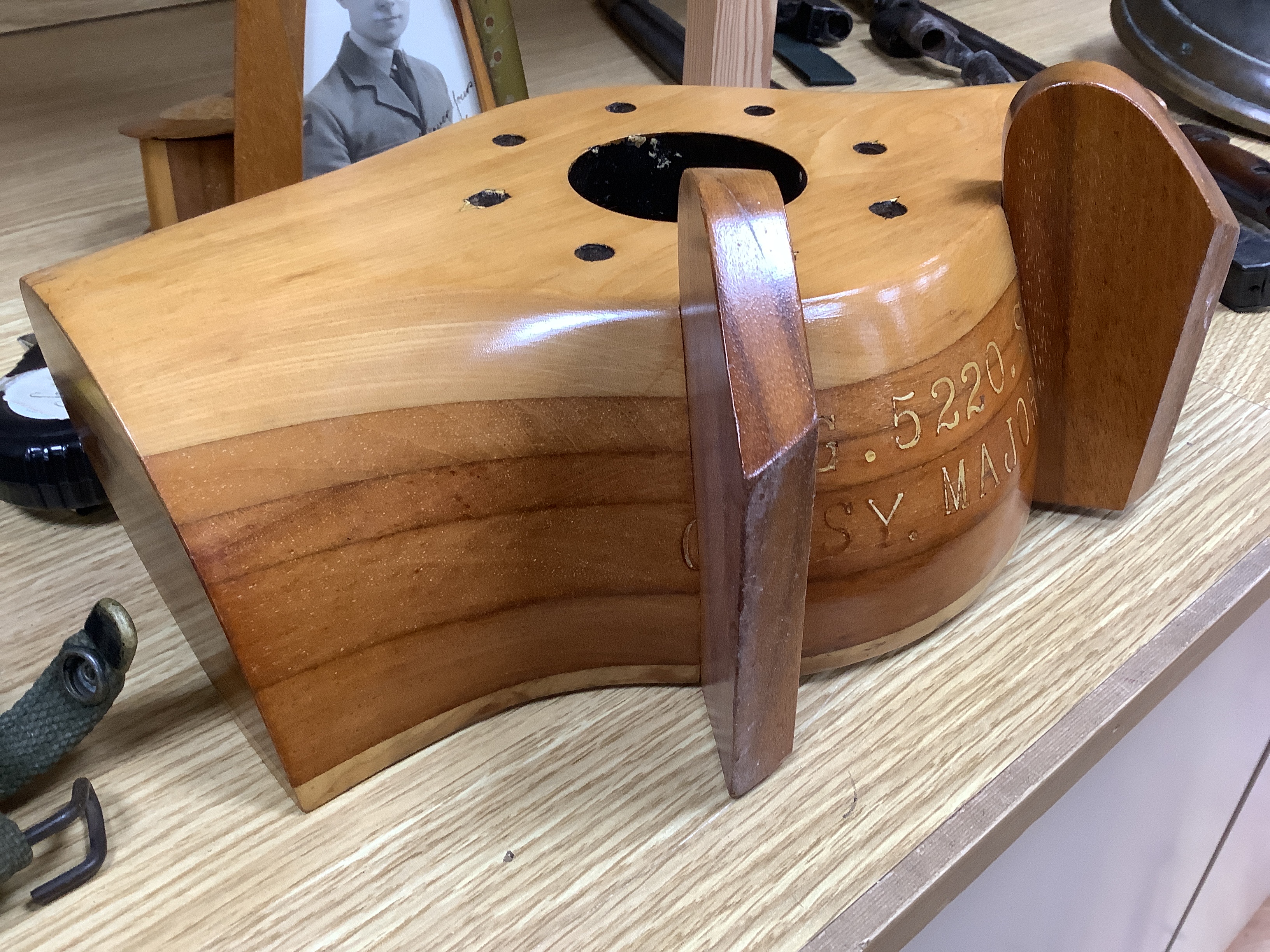 A WWII wooden propeller clock case, reputedly from a Spitfire related photo frame housing a black and white photograph of a soldier together with a trinket box, 35cm wide